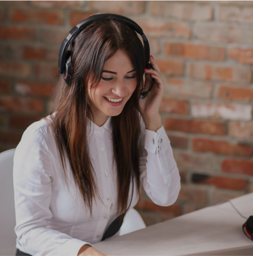 A woman smiling and wearing a headset